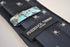 navy tie with white spider silhouette design